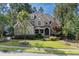Well-maintained home with a lush green lawn, stone accents, and a inviting covered front porch at 633 Rolling Springs Dr, Cary, NC 27519