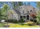 Attractive two-story home with a manicured lawn, mature landscaping, and an inviting front porch at 633 Rolling Springs Dr, Cary, NC 27519