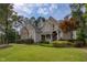 Beautifully landscaped two-story home with a stone chimney and classic architectural details at 633 Rolling Springs Dr, Cary, NC 27519