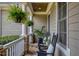 Cozy front porch featuring rocking chairs, ferns and stone accents for relaxing outdoors at 633 Rolling Springs Dr, Cary, NC 27519