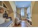 Inviting hallway leading to a home office, complete with built-in storage and hardwood floors at 633 Rolling Springs Dr, Cary, NC 27519