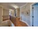 Upstairs hallway with hardwood floors, neutral walls and white trim, leading to various rooms at 633 Rolling Springs Dr, Cary, NC 27519