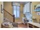 Comfortable home office with custom built-ins, natural light, and adjacent stairs at 633 Rolling Springs Dr, Cary, NC 27519