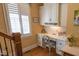 Bright home office featuring custom built-ins, hardwood floors, and natural light from shuttered windows at 633 Rolling Springs Dr, Cary, NC 27519