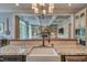 Spacious kitchen with farmhouse sink, granite counters, stainless appliances, and views into the cozy living room at 633 Rolling Springs Dr, Cary, NC 27519