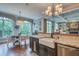 Bright eat-in kitchen with stainless appliances, farmhouse sink, granite counters, large windows, and hardwood flooring at 633 Rolling Springs Dr, Cary, NC 27519
