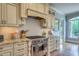 Gourmet kitchen with stainless steel range, custom cabinetry, and stone countertops at 633 Rolling Springs Dr, Cary, NC 27519