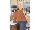 Beautiful kitchen island with butcher block countertop, granite counters, and a cozy breakfast bar with wicker chairs at 633 Rolling Springs Dr, Cary, NC 27519
