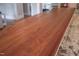 Kitchen island featuring a wood countertop, granite counters, and seating, perfect for casual dining and meal preparation at 633 Rolling Springs Dr, Cary, NC 27519