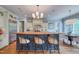 Stunning kitchen featuring an island with seating, custom cabinets, and stainless steel appliances at 633 Rolling Springs Dr, Cary, NC 27519