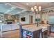 Open-concept kitchen with granite counters, stainless appliances, island, and views into the adjacent living room with fireplace at 633 Rolling Springs Dr, Cary, NC 27519