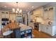 Open kitchen boasting stone countertops, island seating, and high-end appliances at 633 Rolling Springs Dr, Cary, NC 27519