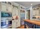 Well-equipped kitchen with stainless steel appliances, custom cabinets, granite countertops, and hardwood floors at 633 Rolling Springs Dr, Cary, NC 27519