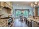 Bright kitchen with stainless steel appliances, farmhouse sink, and view to the breakfast area at 633 Rolling Springs Dr, Cary, NC 27519