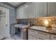 Well-equipped laundry room featuring modern washer and dryer, ample storage and utility sink at 633 Rolling Springs Dr, Cary, NC 27519