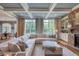 Bright living room features coffered ceiling, stone fireplace, and large windows overlooking the lush outdoors at 633 Rolling Springs Dr, Cary, NC 27519