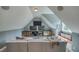 Large living room under angled roof features entertainment center with three TV's and window seat at 633 Rolling Springs Dr, Cary, NC 27519