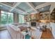Open concept living room featuring coffered ceilings, stone fireplace, built-in shelving, and large windows at 633 Rolling Springs Dr, Cary, NC 27519