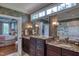 Bathroom featuring dual sinks, granite countertops, and a view into the stunning main bedroom at 633 Rolling Springs Dr, Cary, NC 27519