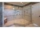 Spacious walk-in shower boasts multiple shower heads and custom tile work and glass enclosure at 633 Rolling Springs Dr, Cary, NC 27519