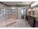 Main bathroom with a glass-enclosed shower, dual vanity, and decorative wallpaper at 633 Rolling Springs Dr, Cary, NC 27519