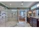 Beautiful bathroom with a large shower, dual vanity, and a glimpse into the elegant main bedroom at 633 Rolling Springs Dr, Cary, NC 27519