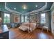 Spacious main bedroom with a four-poster bed, tray ceiling, and ample natural light at 633 Rolling Springs Dr, Cary, NC 27519