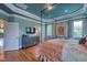 Large main bedroom featuring hardwood floors, stylish decor, and a view into the ensuite bathroom at 633 Rolling Springs Dr, Cary, NC 27519