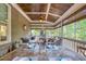 Cozy screened-in porch with a ceiling fan and outdoor dining area at 633 Rolling Springs Dr, Cary, NC 27519