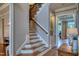 Elegant staircase with wooden steps, decorative runner and views into other living areas at 633 Rolling Springs Dr, Cary, NC 27519