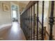 Inviting staircase with detailed wrought iron balusters and rich hardwood flooring, offering classic elegance at 633 Rolling Springs Dr, Cary, NC 27519