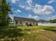 Spacious backyard with a patio, privacy fence, lush grass, and a well-maintained lawn at 710 Country Rd, Middlesex, NC 27557