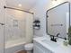 Cozy bathroom featuring a combined shower and bathtub, tiled walls, and modern fixtures at 710 Country Rd, Middlesex, NC 27557