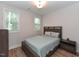 Comfortable bedroom with hardwood floors, natural light, and contemporary decor at 710 Country Rd, Middlesex, NC 27557
