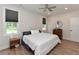 Bright bedroom with a large bed, two windows with view, a ceiling fan and a dresser at 710 Country Rd, Middlesex, NC 27557