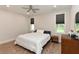 Bright bedroom with hardwood floors, ceiling fan, and two windows at 710 Country Rd, Middlesex, NC 27557