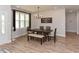 Elegant dining room with wooden table, chairs, bench, modern light fixture, and large windows offering lots of sunlight at 710 Country Rd, Middlesex, NC 27557