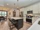 Bright kitchen featuring an island with bar stools, stainless steel appliances, and dining area with lots of sunlight at 710 Country Rd, Middlesex, NC 27557