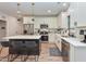 Modern kitchen with stainless steel appliances, white cabinets, island with bar seating and hanging pendant lights at 710 Country Rd, Middlesex, NC 27557