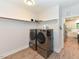 A convenient laundry room with stainless steel washer and dryer, and a shelf for storage at 710 Country Rd, Middlesex, NC 27557