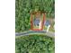 Aerial view showcasing the home's location within a lush, wooded neighborhood at 720 The Parks Dr, Pittsboro, NC 27312