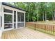 Back deck showcasing the screened porch area and outdoor wooded views at 720 The Parks Dr, Pittsboro, NC 27312