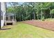 Expansive backyard with lush green lawn and newly mulched garden beds at 720 The Parks Dr, Pittsboro, NC 27312