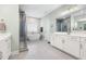 Luxurious bathroom with modern fixtures, a glass shower, a soaking tub and dual vanities at 720 The Parks Dr, Pittsboro, NC 27312