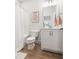 Bathroom featuring a shower with curtain, white vanity, wood-look flooring, and cheerful decor at 720 The Parks Dr, Pittsboro, NC 27312