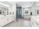 Modern bathroom with a soaking tub, a glass shower, dual vanities, and neutral tile at 720 The Parks Dr, Pittsboro, NC 27312