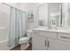 Well-lit bathroom featuring a shower with a neutral colored shower curtain at 720 The Parks Dr, Pittsboro, NC 27312