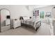 Bright bedroom featuring a modern bed frame, white nightstands, and natural light at 720 The Parks Dr, Pittsboro, NC 27312