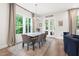Sun-filled dining area featuring an elegant chandelier and views of the outdoors at 720 The Parks Dr, Pittsboro, NC 27312