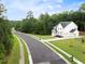 Attractive two-story home with a white exterior, manicured lawn, and three-car garage at 720 The Parks Dr, Pittsboro, NC 27312